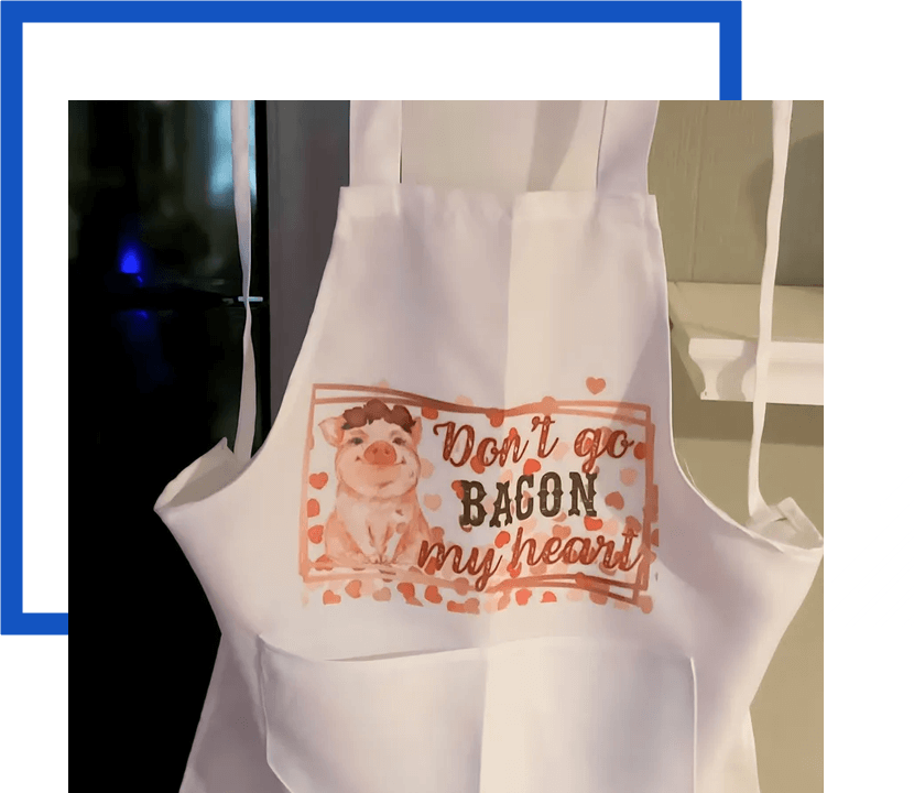 A white apron with an image of bacon on it.
