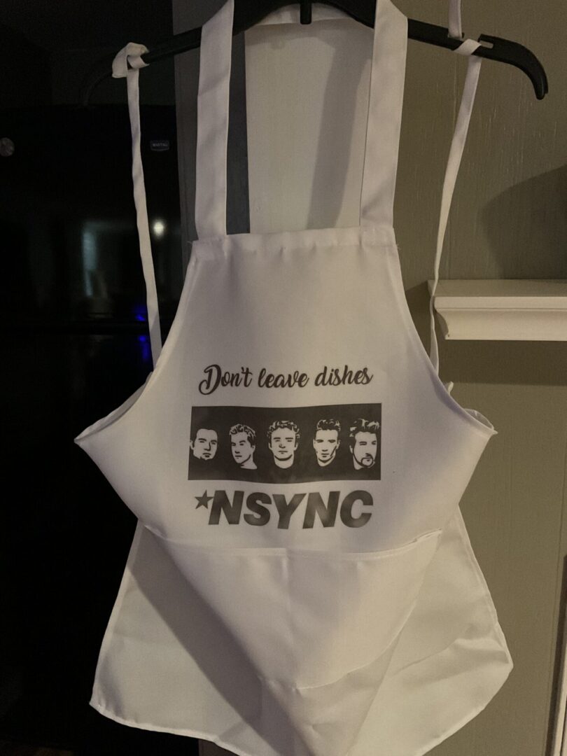 A white apron with some faces on it
