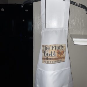 A white apron with the words " the fluffy butt ".