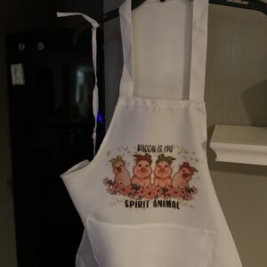 A white apron with three pigs on it.