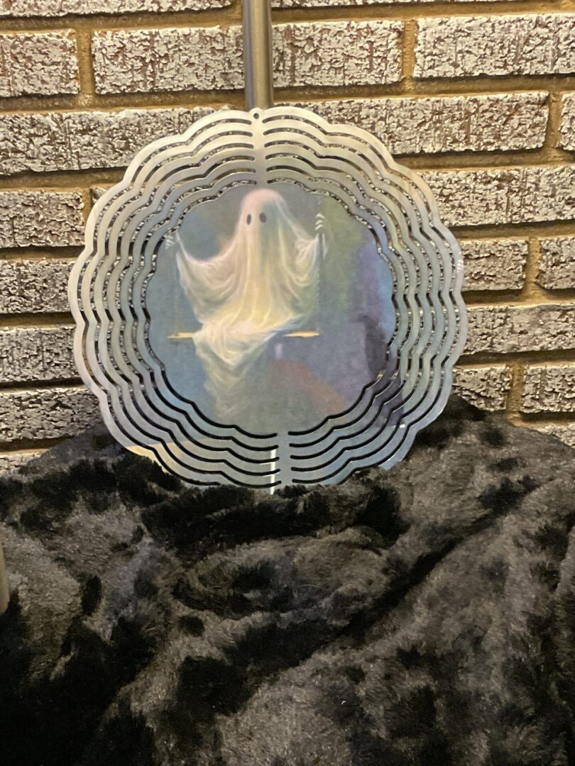 A ghost fan sitting on top of a black blanket.