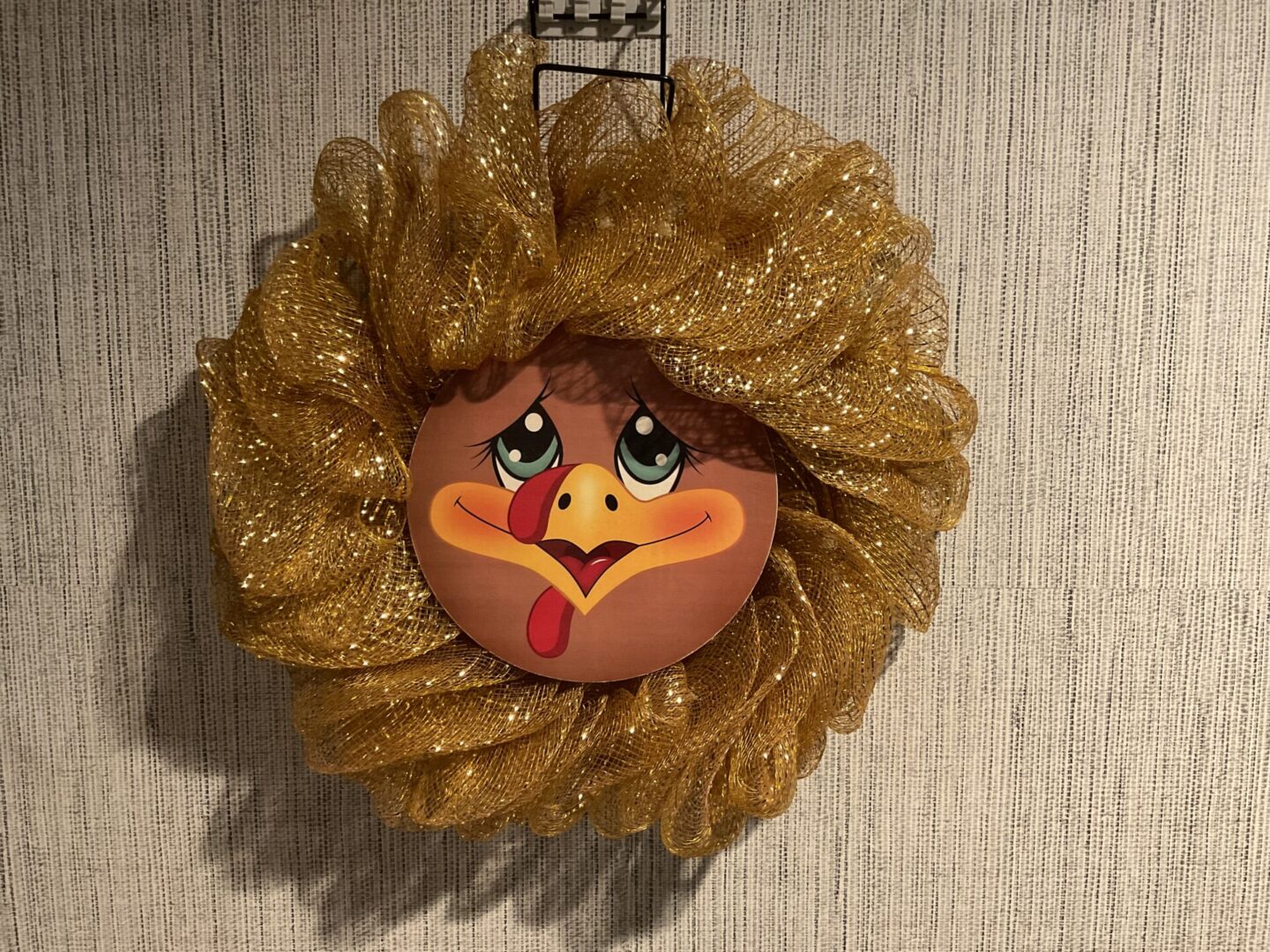 A turkey head ornament hanging on the wall.