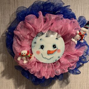 A pink and blue flower with a snowman face on it.