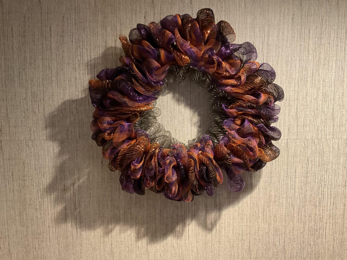A wreath made of purple and brown fabric.