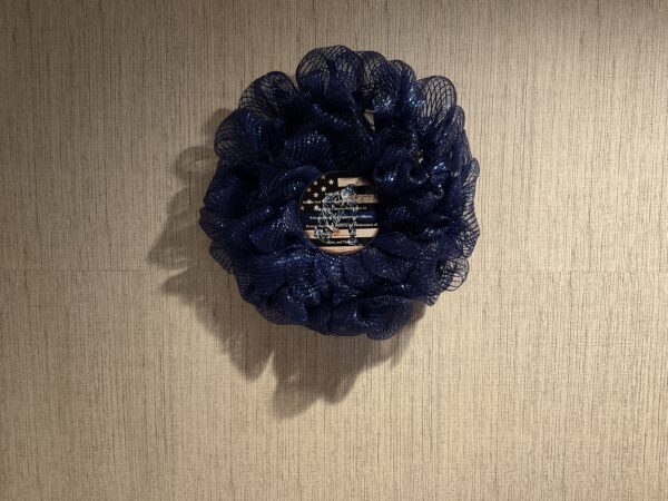 A wreath of blue fabric with an american flag on it.