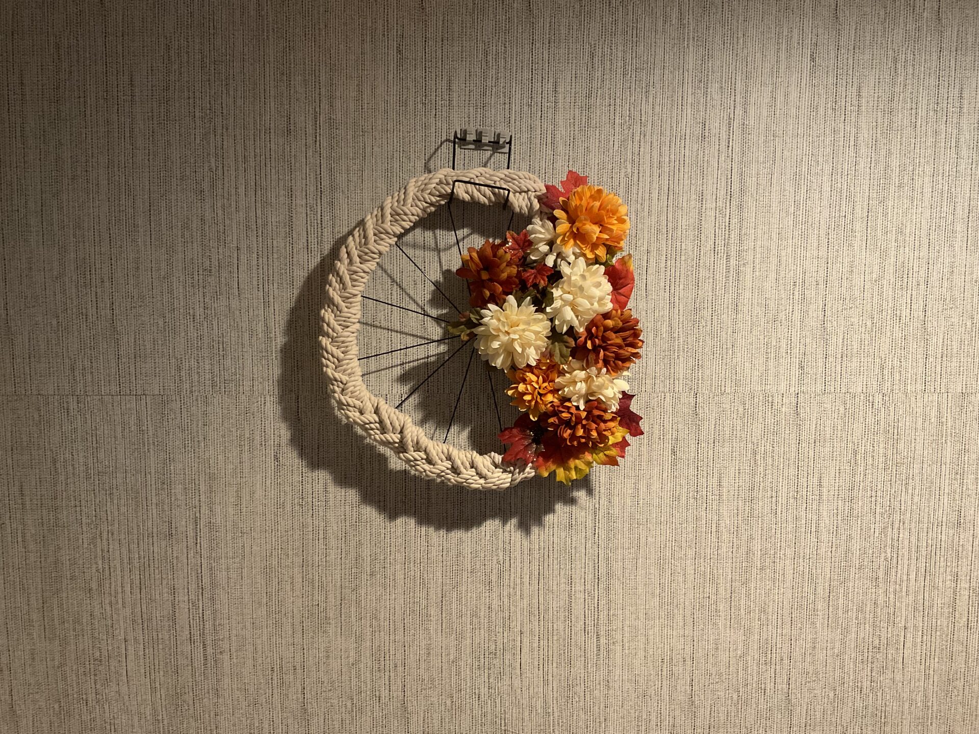 A wreath of flowers hanging on the wall.