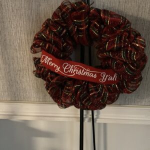A red and white wreath hanging on the wall.