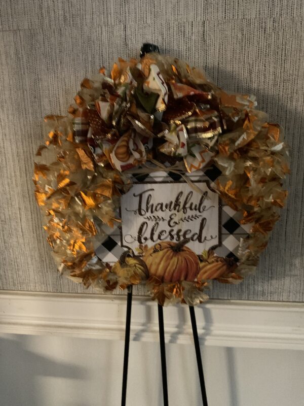 A wreath with leaves and a sign that says " thankful & blessed ".