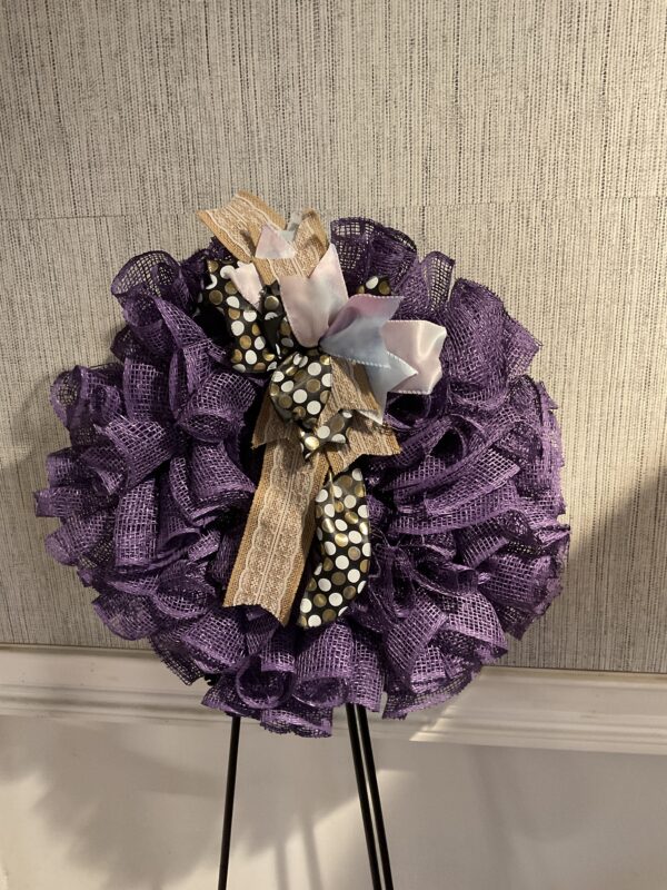 A purple wreath with a cross on it.