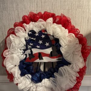 A wreath with red, white and blue ribbons.