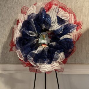 A red white and blue flower with a face on it