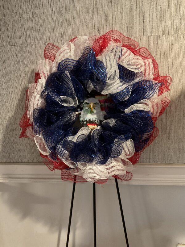 A red white and blue flower with a face on it
