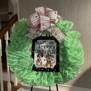 A green wreath with a bow and some pictures
