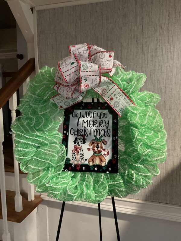 A green wreath with a bow and some pictures