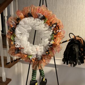 A wreath is on display in front of the stairs.