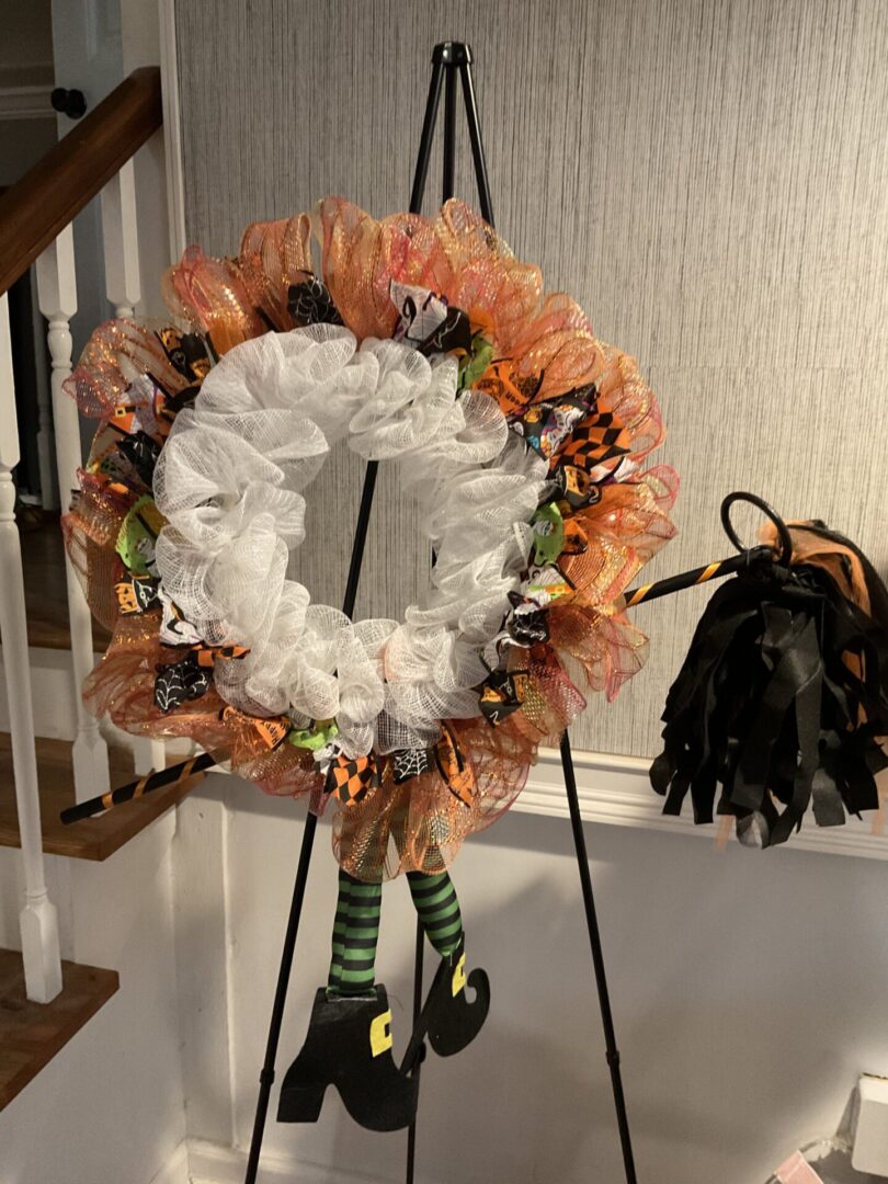 A wreath is on display in front of the stairs.