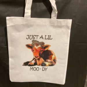 A bag that has a picture of a cow on it.