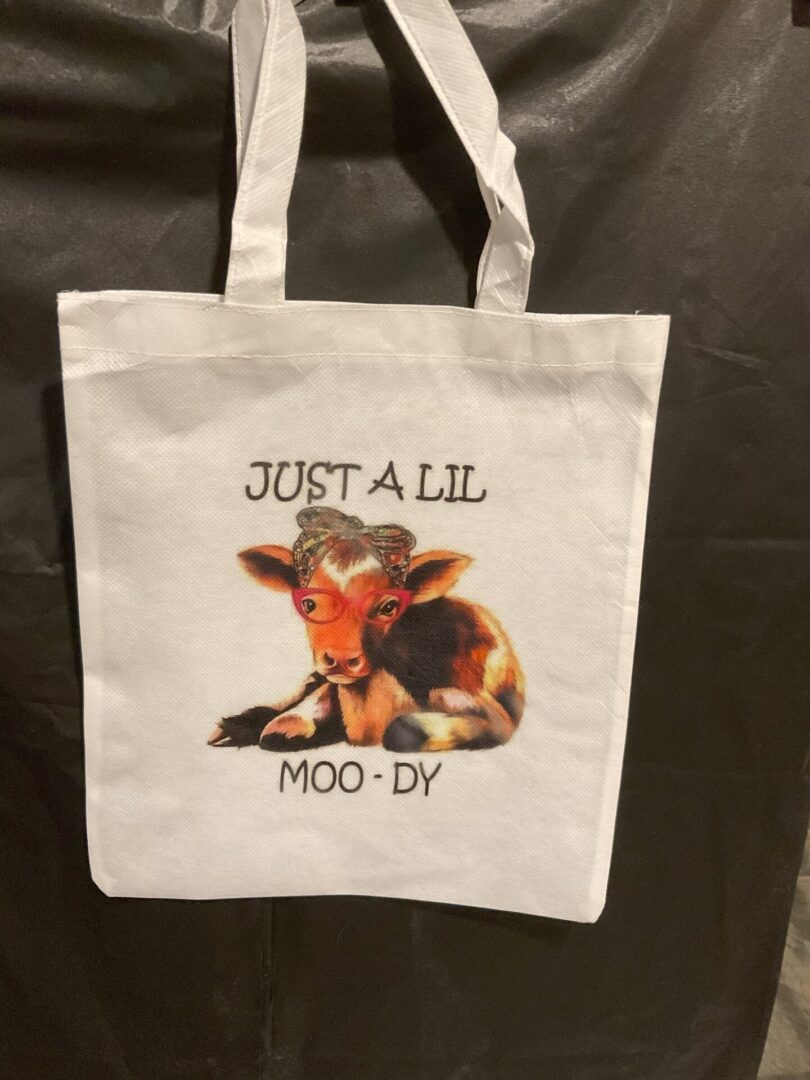 A bag that has a picture of a cow on it.
