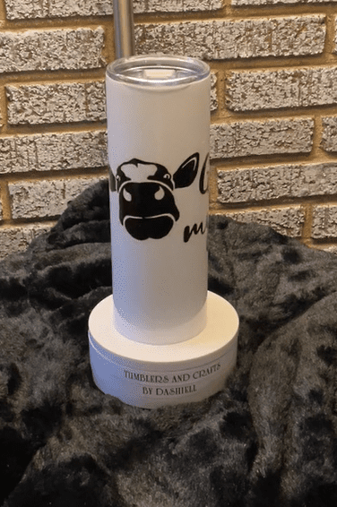 A candle holder with a cow on it