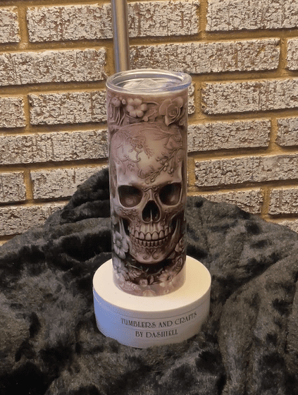 A skull candle is sitting on the ground.