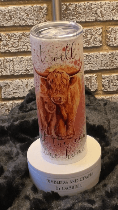 A candle with an image of a cow on it.