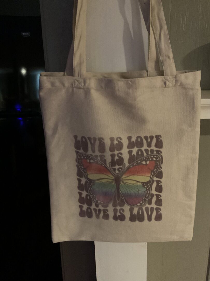 A bag that has been printed with the words " love is love ".